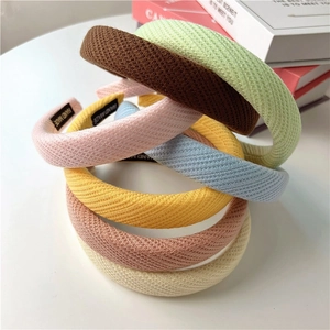 Macro shot of colorful waffle fabric headbands featuring a handmade woven label detail