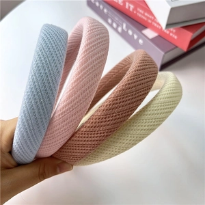 Detail showing the thick sponge padding and knitted texture in four soft pastel colors