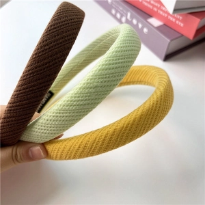 Detail showing the thick waffle knit texture and handmade label on soft sponge headbands