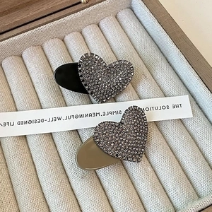 Exquisite heart-shaped rhinestone hair clips set in black and taupe with micro-pave crystals