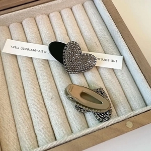 Exquisite heart-shaped rhinestone hair clips in a grey velvet jewelry box display