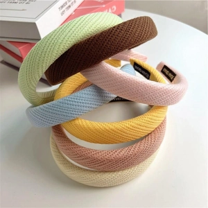 Stack of colorful waffle knit sponge headbands in cream, green and pink Korean style