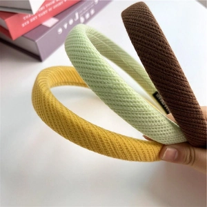 Three waffle texture headbands in green, yellow and brown colors for daily hair styling