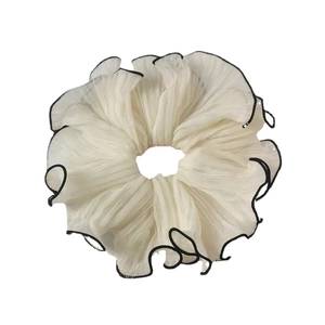 Elegant cream pleated chiffon scrunchie with black contrast edges for stylish ponytails