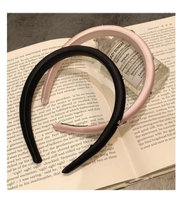Detail of elegant black and pink satin padded headbands on decorative books