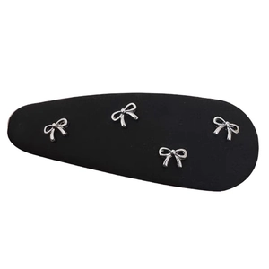Elegant matte black hair clip with four silver metal bows in a teardrop BB style
