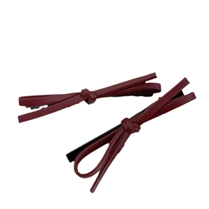 Dark red leather bow hair clips with black alligator grip for elegant hair styling