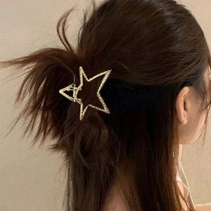 Golden star-shaped metal hair claw clip with twisted texture for women's hairstyles