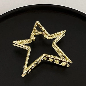 Minimalist gold star hair claw clip with unique hammered metal finish for women