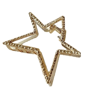Elegant gold pentagram star claw clip with hammered metal texture for women