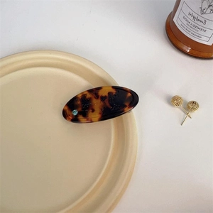 Tortoiseshell acrylic hair clip with blue crystal detail and gold ball earrings set