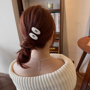 Elegant tweed bow hair clips set for women displayed on a model in a cozy setting