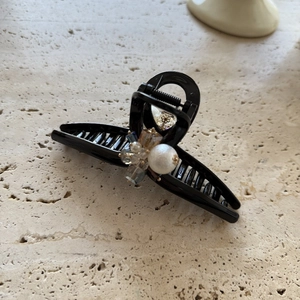 Elegant pearl and crystal beaded hair claw clip for women on a stone surface