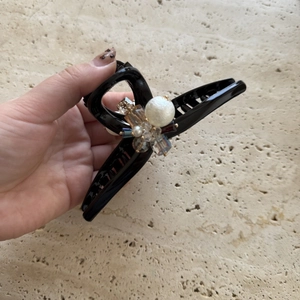 Elegant pearl and crystal hair claw clip with handmade beaded design on a black clamp