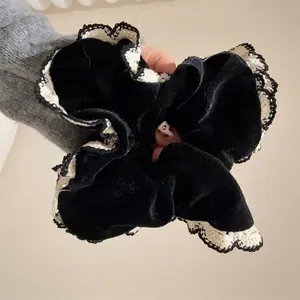 Elegant black velvet large scrunchie with white lace trim for chic hair styling