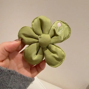 Green fabric flower hair clip with cute embroidery in a minimalist Korean style design