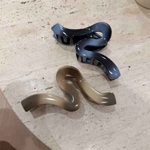 Large wave-shaped hair claw clips with gradient finish for thick hair styling