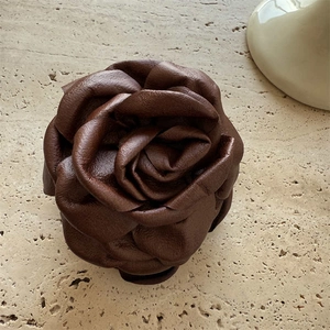 Elegantly crafted dark brown leather camellia flower hair clip with realistic textures