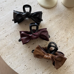 Three-piece set of glossy leather bow hair claws in black, burgundy, and brown colors