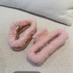 Set of two soft pink plush hair claws with fluffy texture for elegant winter styling