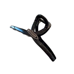 Glossy black oversized hair claw clip with sparkling rhinestone inlay for elegant hairstyles