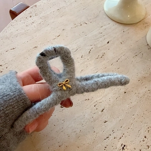 Winter plush grey hair claw clip with golden bow accent for thick hair styling