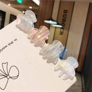 Detailed set of four mini acetate hair claw clips in various elegant translucent colors