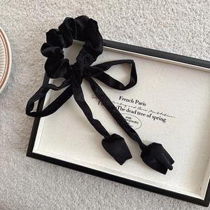 Macro shot of French vintage black ribbed texture fabric long bow hair tie detail