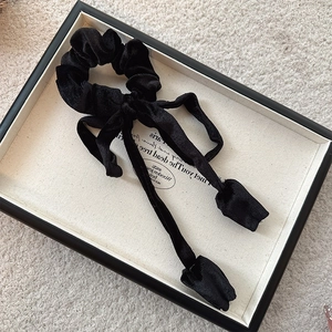 Elegant French vintage black velvet hair scrunchie with long ribbon bow on a jewelry tray