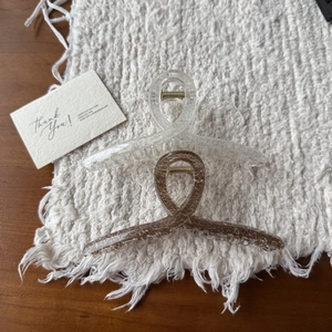 Detail of two geometric hair claws in transparent and amber with ice-crack texture