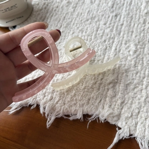 Close-up of matte resin hair claws in pink and cream with durable metal springs