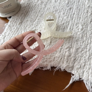 Close-up of a premium large translucent jelly pink hair claw clip held in hand