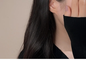 Detailed close-up of a black knit long sleeve shirt fabric texture and slim fit design