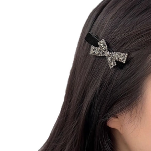 Elegant black bow hair clip with shimmering silver rhinestones for women hair styling