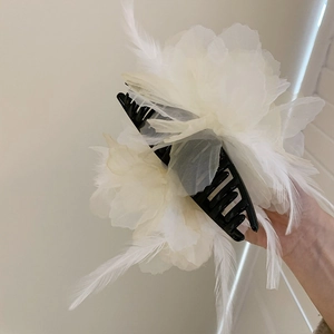 Elegant black shark hair claw with large white organza flower and long feather accents