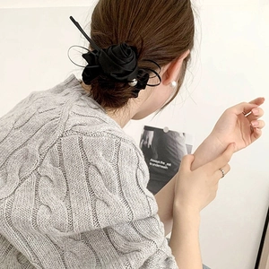 Elegant black satin rose hair scrunchie with center pearl on woman's updo hairstyle