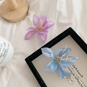 Barrettes à cheveux fleurs de magnolia dégradées violettes et bleues sur tissu blanc