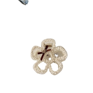 Elegant white pearl flower hair claw clip with a brown ribbon bow and golden heart pendant