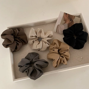 Elegant satin hair scrunchies set in neutral brown earth tones for women's hairstyles