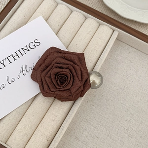 Detail view of dried rose hair claw clip with silk petals and a silver metallic bead accent