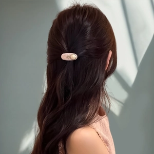 Elegant Korean style tweed hair clip with pearl embellishment on model for women