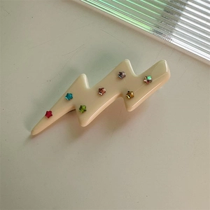 Schicke Haarspange in Blitzform in Cremeweiß mit bunten Stern-Strasssteinen