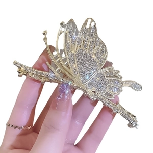 Elegant gold butterfly hair claw clip with sparkling rhinestones and hollow metal design