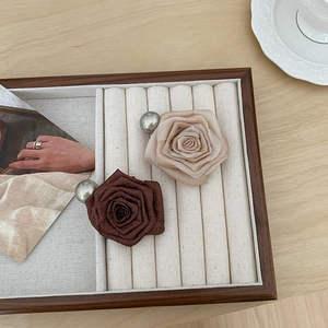 Elegant fabric rose shark hair clips in beige and brown colors for a stylish ponytail