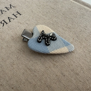 Cute heart-shaped blue checkered fabric hair clip with a small black dog pattern