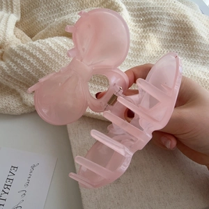 Pink translucent bow-shaped hair claw clip with strong metal spring for thick hair