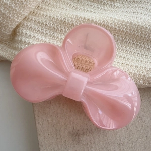 Pink bow hair claw clip made of glossy acrylic with metal spring for women's hair styling