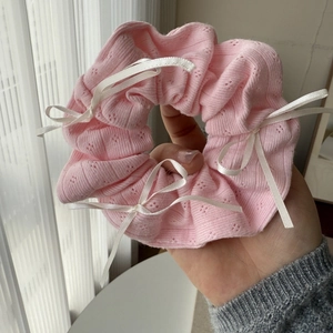 Pink knit scrunchie with white satin bows and ruffled edges in sweet balletcore style