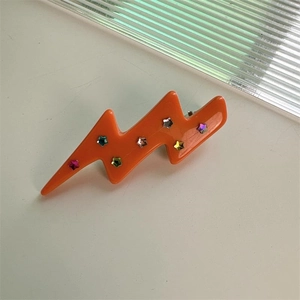 Einzigartige Haarspange in Blitzform aus orangefarbenem Acetat mit bunten Stern-Pailletten