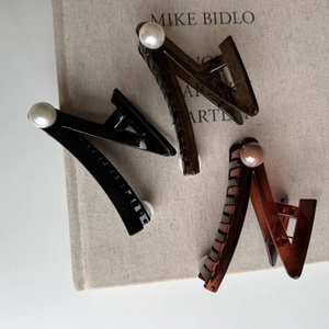 Three-piece set of large pearl hair claws in black, amber, and translucent brown colors